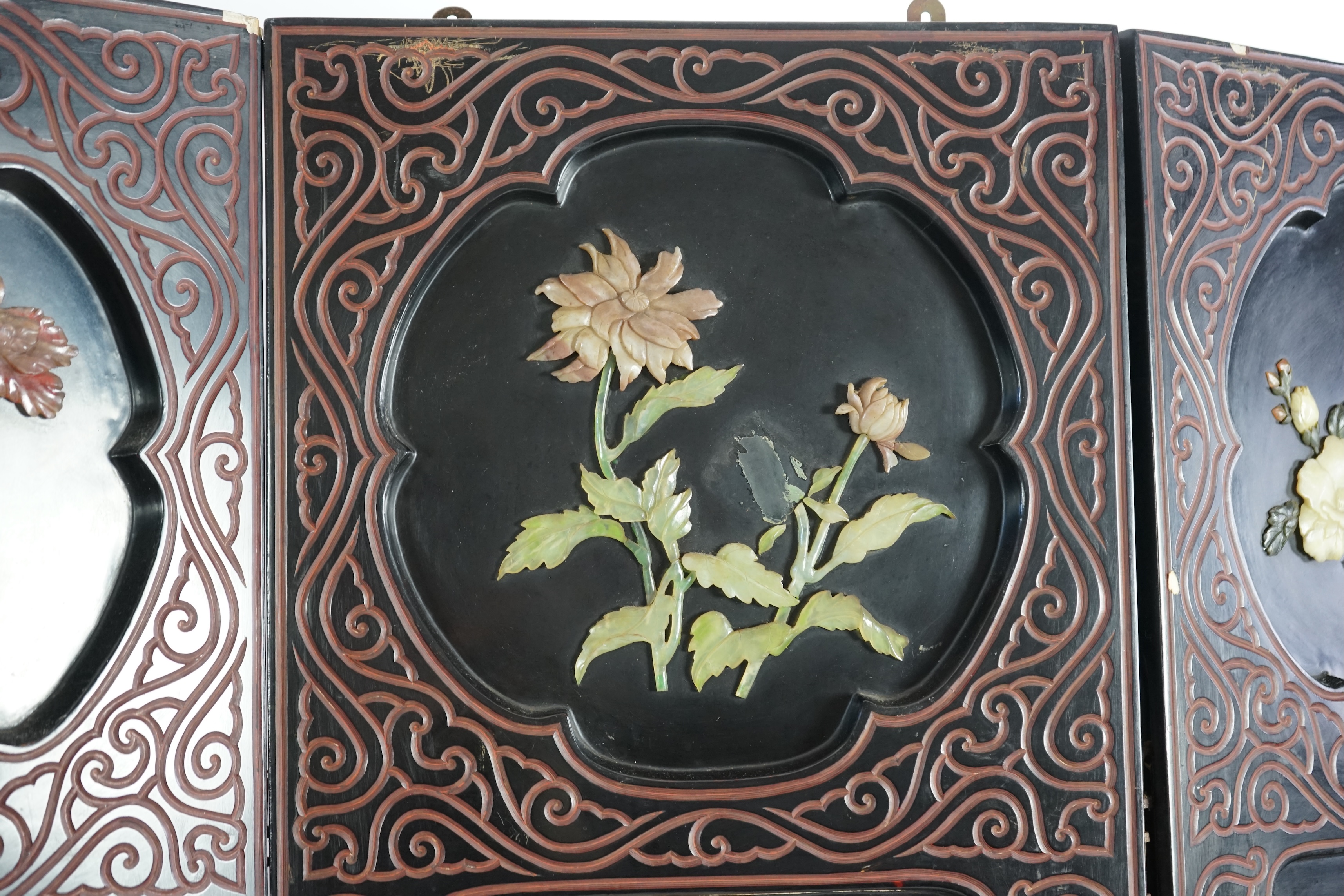 A Chinese tixi lacquer and carved soapstone overlaid six panel screen, mid 20th century